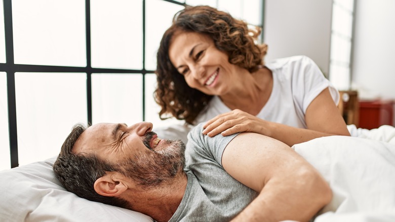 Smiling man and woman waking up