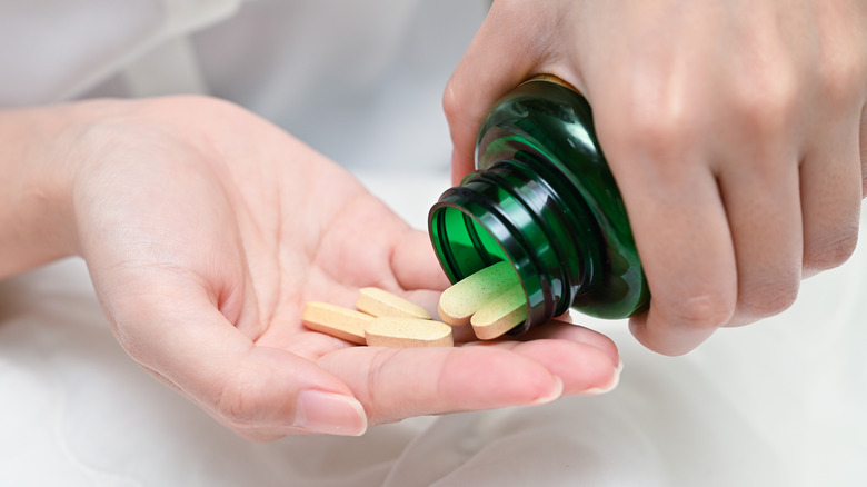 pouring multivitamins into hand