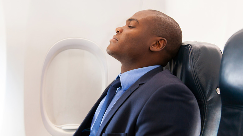tired man on airplane