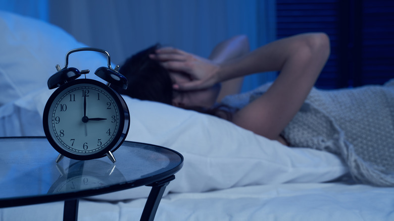 woman in bed struggling with insomnia
