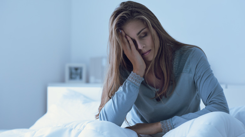 depressed woman sitting in bed