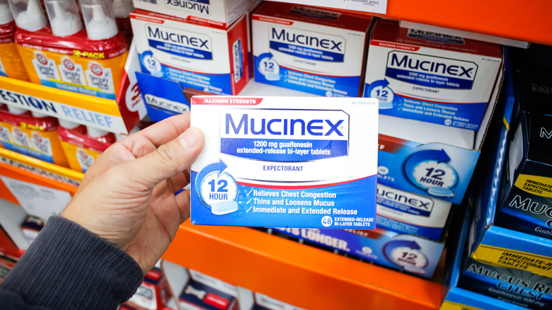 shopper holding mucinex