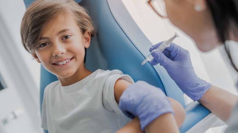 Smiling child receives vaccine