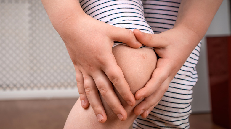 Boy holding a bruised knee