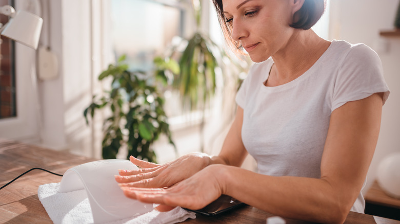 Woman looking at nails