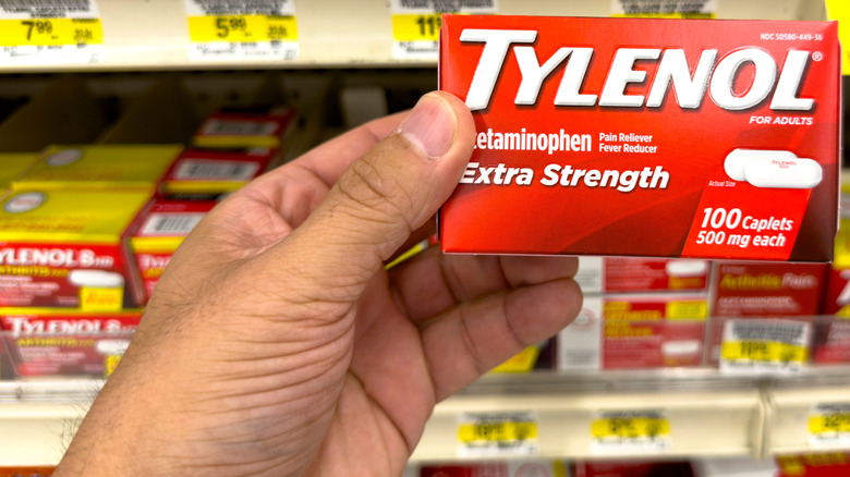 male hand holding package of Tylenol