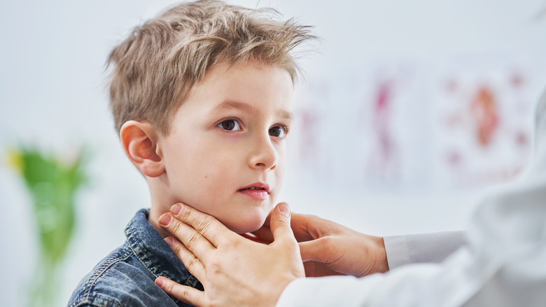 Child being examined for mumps