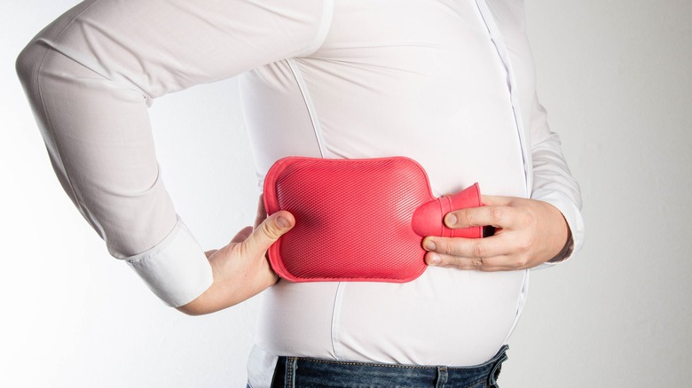 man holding a hot water bottle