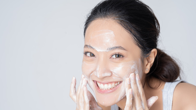 woman washing her face