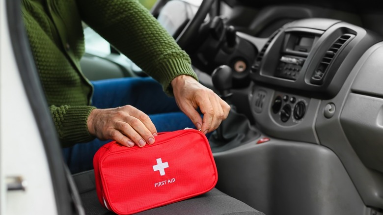 Man reaching for first aid kit 
