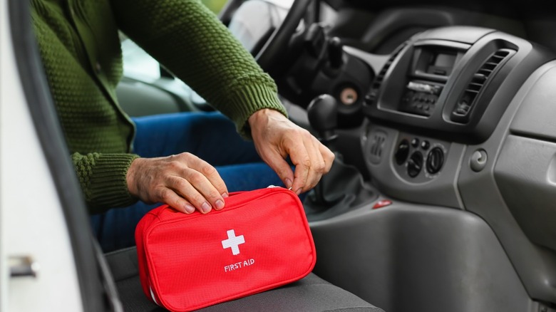 Man reaching for first aid kit