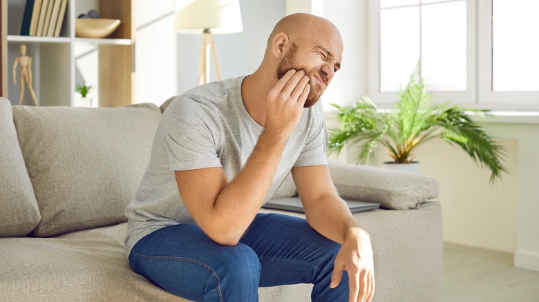 man holding jaw