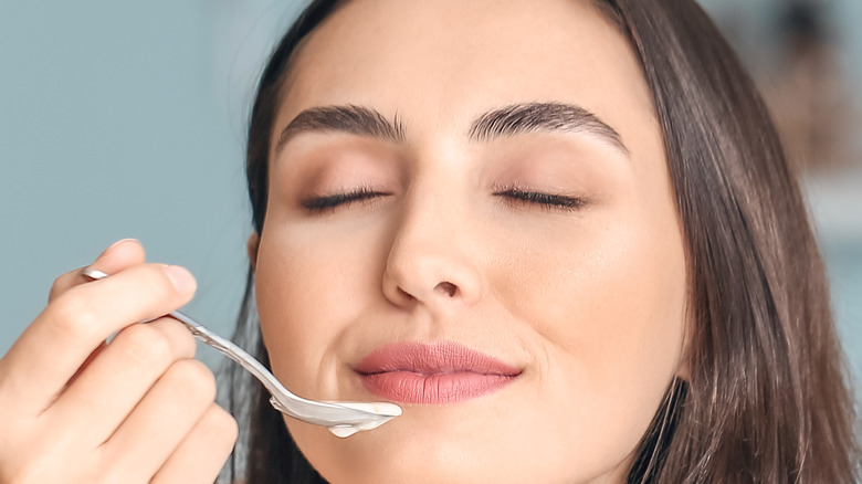 woman eating smoothie ice cream