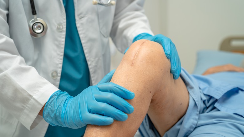 Surgeon holding patient's knee