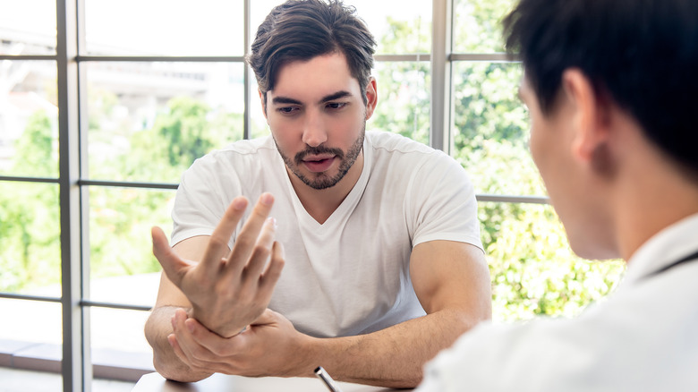 man speaking with doctor