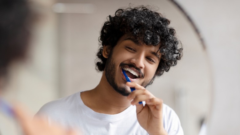 A man brushes his teeth