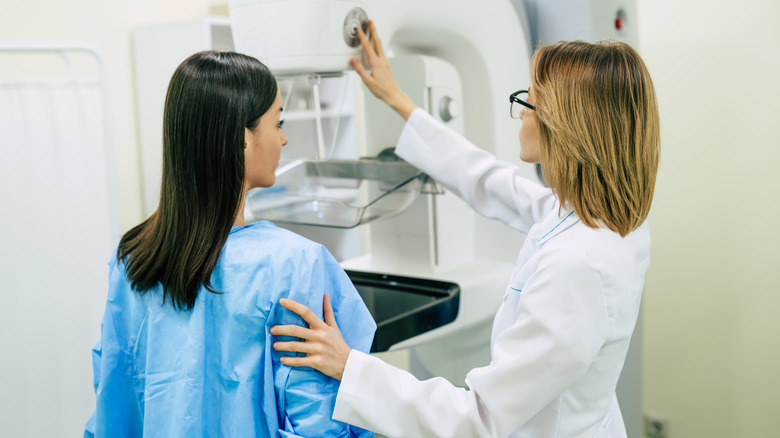 Woman preparing to undergo mammogram