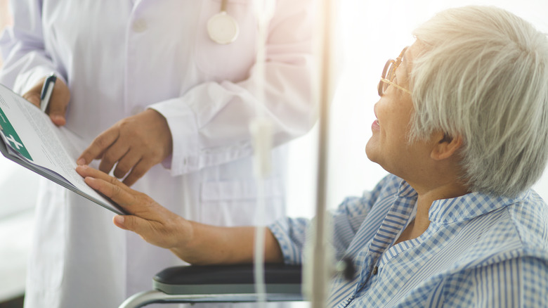 Woman undergoing chemotherapy speaking to doctor