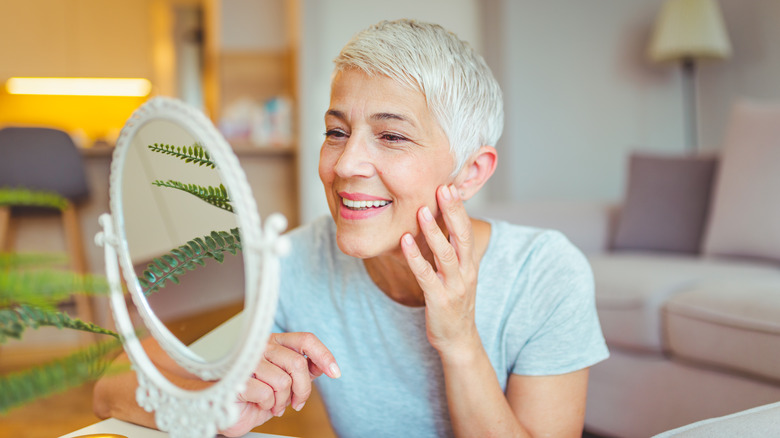 a woman has her face marked for plastic surgery 