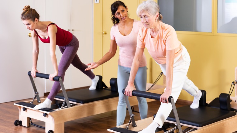 Small reformer Pilates class with instructor