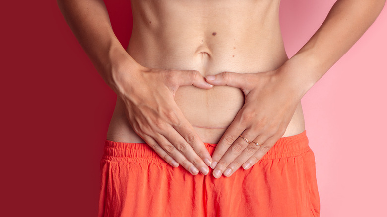 woman making heart over cesarean scar