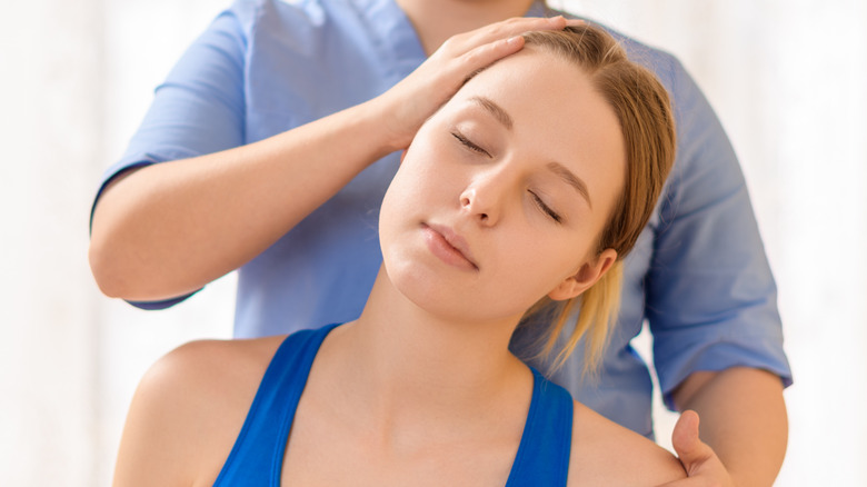 Woman getting chiropractic neck adjustment