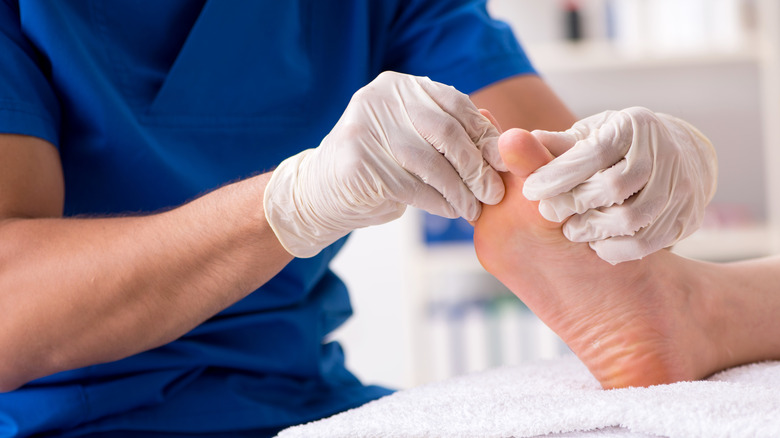 A podiatrist treats a patient's foot