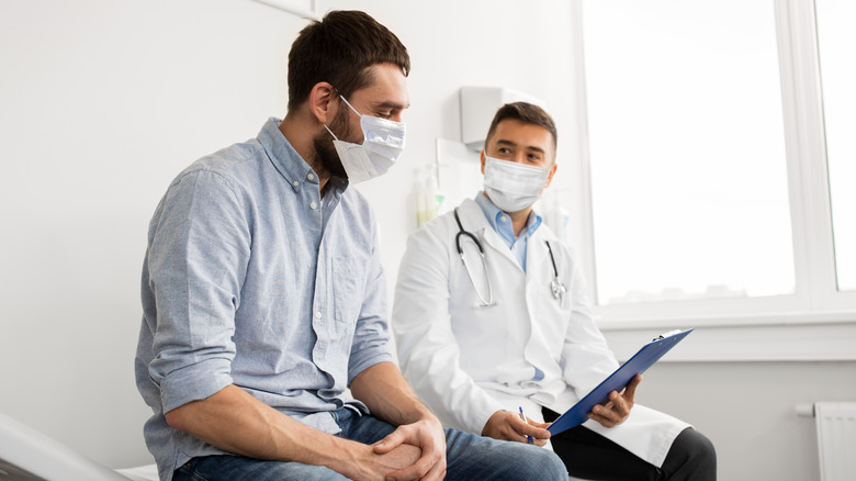 Man and urologist talking during an exam