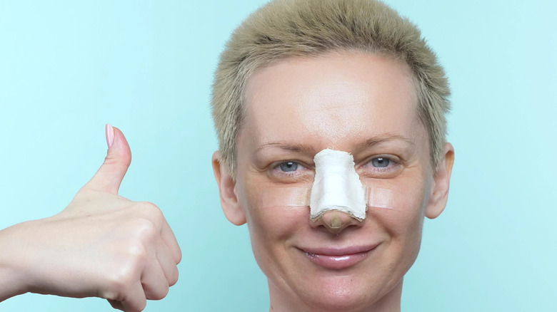 Woman with bandages on nose