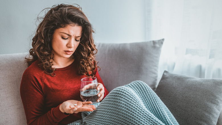 woman taking antidepressant pill