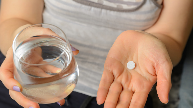 Woman with abortion pill in hand