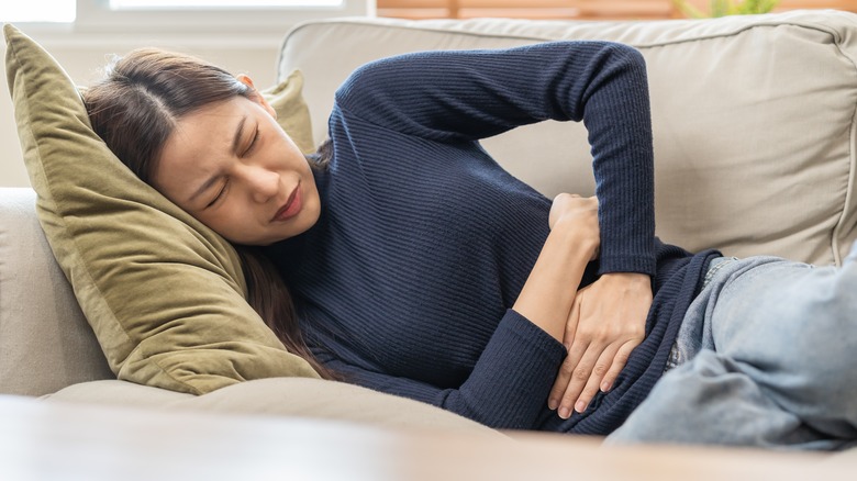 Sick woman resting on couch