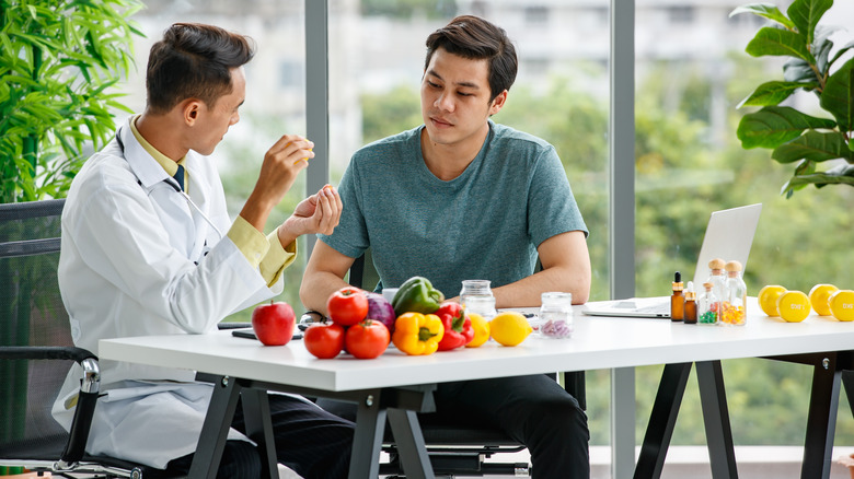 a nutritionist going over a plan with a young man