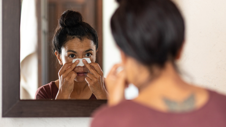 Woman removing blackheads