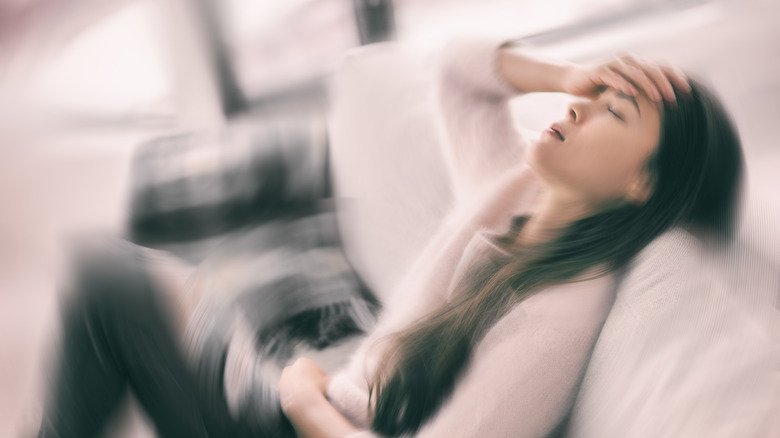Blurry picture of a woman with symptoms of panic attack