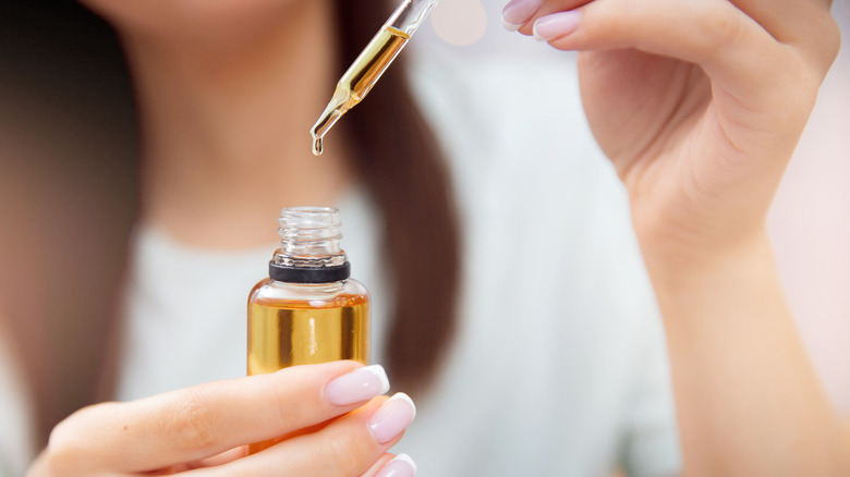 Woman holding argan oil