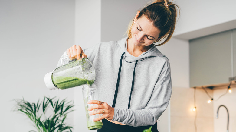 woman preparing smoothie