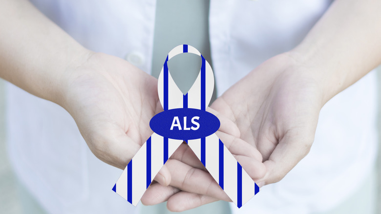 medical professional holding an ALS ribbon
