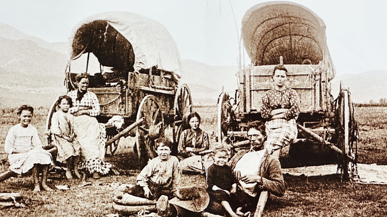 Historic photo of emigrants moving west in covered wagons