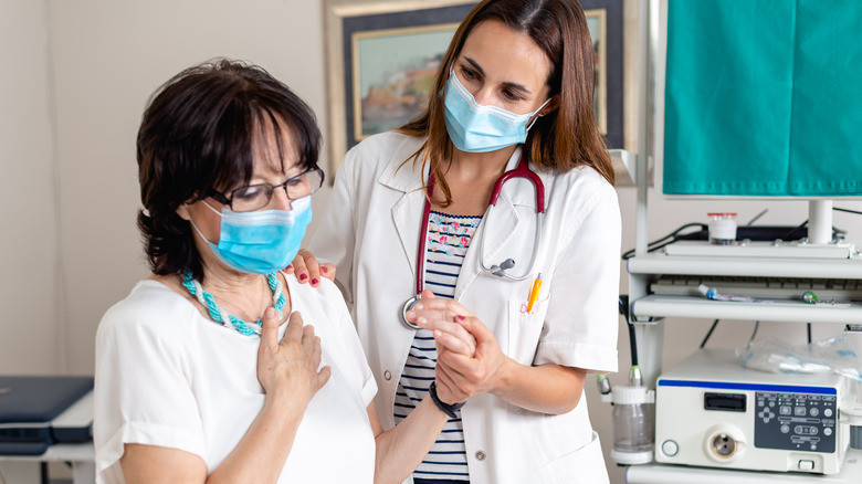 doctor helping patient