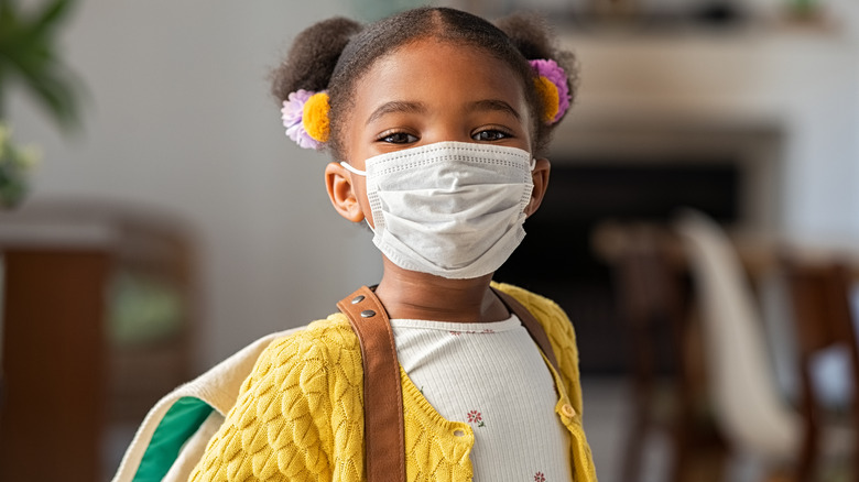 young girl wearing mask