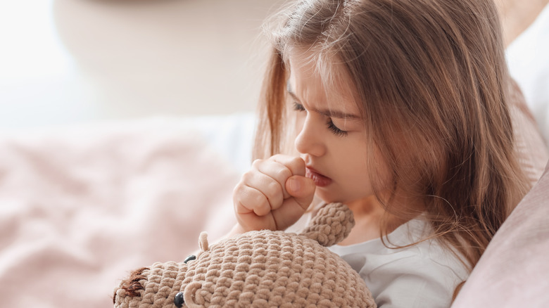 Child sitting on mother's lap at doctor's office