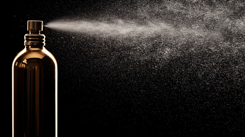 Perfume bottle spraying fragrance 