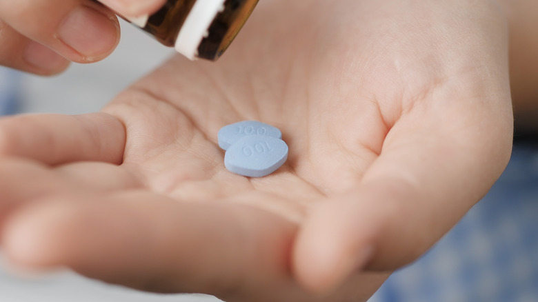 Two Viagra pills in the palm of a person's hand