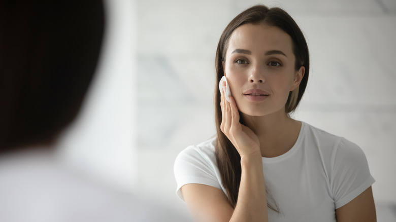 A woman removes her makeup