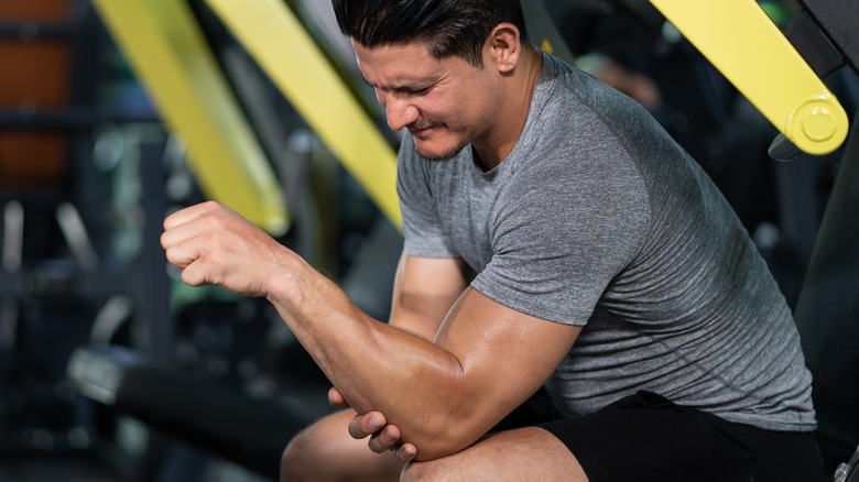 man with sore forearm after workout