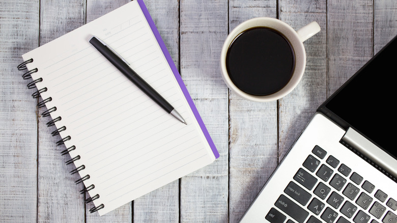 concept of writer with laptop, notepad and coffee