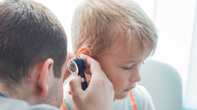 Young boy getting ear exam