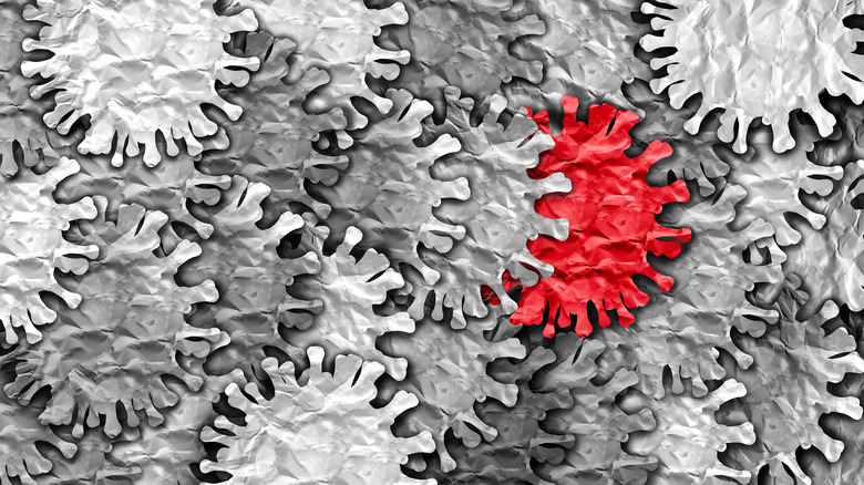 Black and white depiction of SARS-CoV-2 virus with spike proteins; one virus cell is colored red