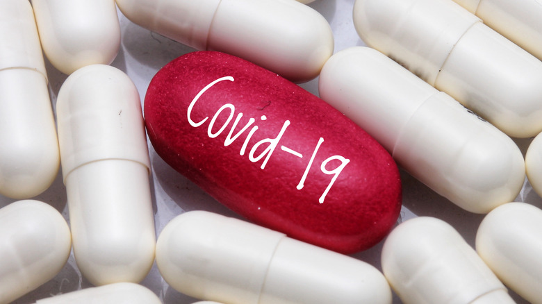 Red COVID-19 pill and white pills